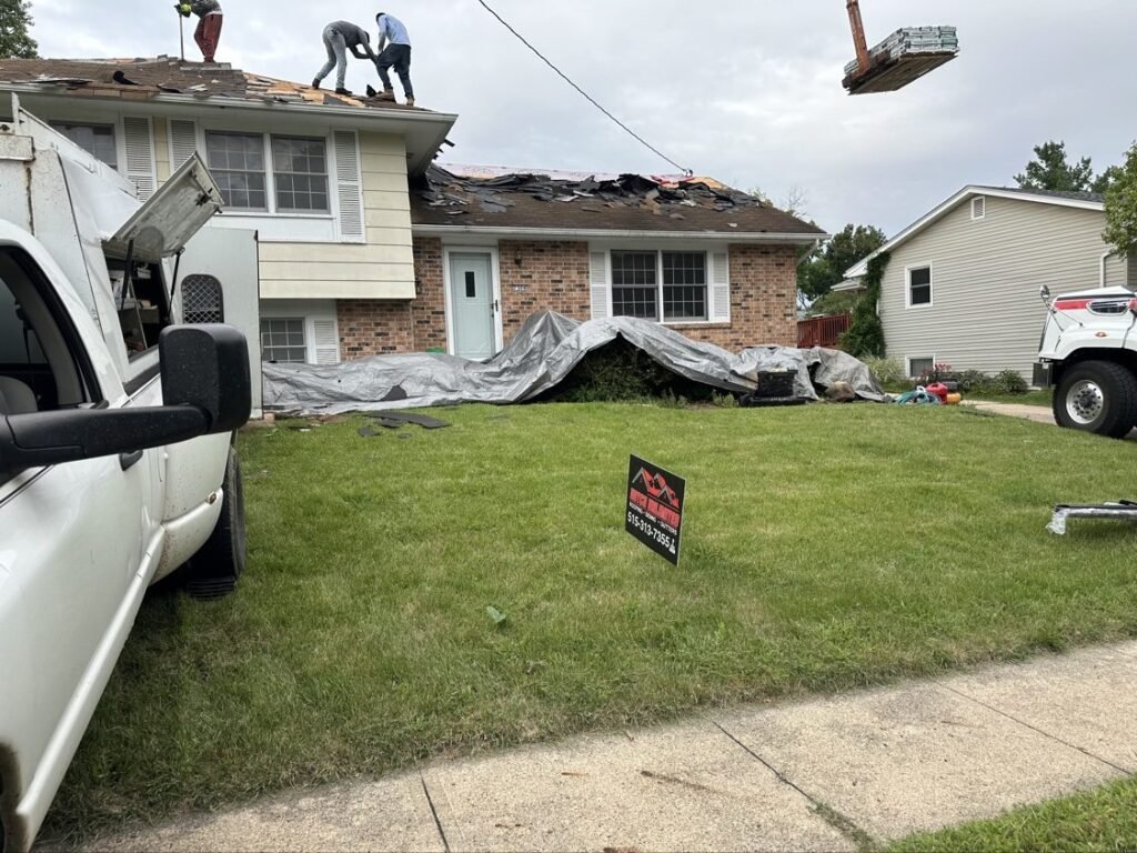 Crew tearing off the old roof down to the decking