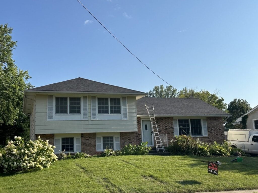 The same split-level home with a completed new shingle roof